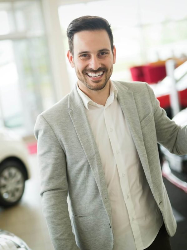 car-salesman-calculating-a-price-at-the-dealership-office.jpg